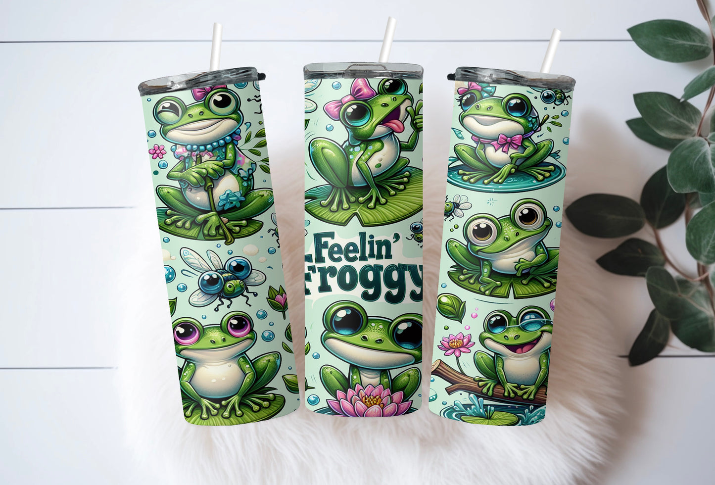 Close-up of cute frog tumbler with bow, lotus flower, and vibrant print